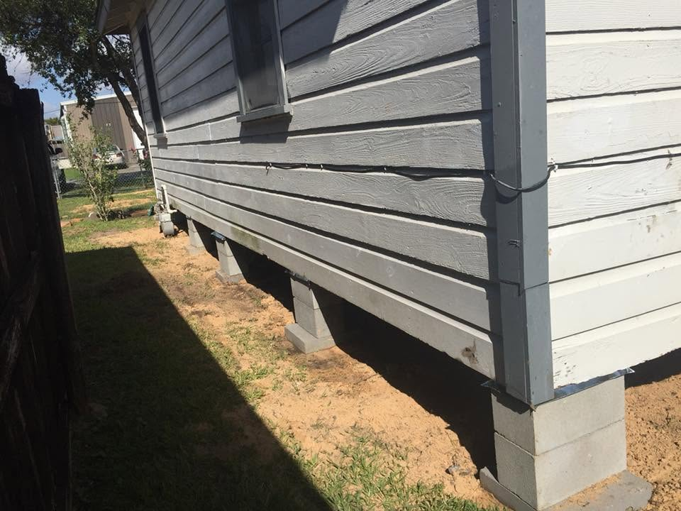 Side view of a raised home supported on concrete blocks